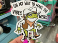 On My Way to Make Vibes Weird Sticker - Funny Cowboy Frog Decal: White Vinyl